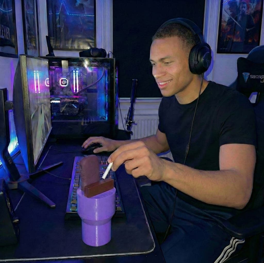 Heat Cup on a gaming desk, holding a heated tobacco device and pack